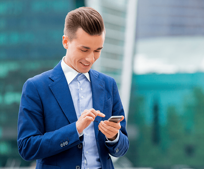 Man smiling and looking at his phone